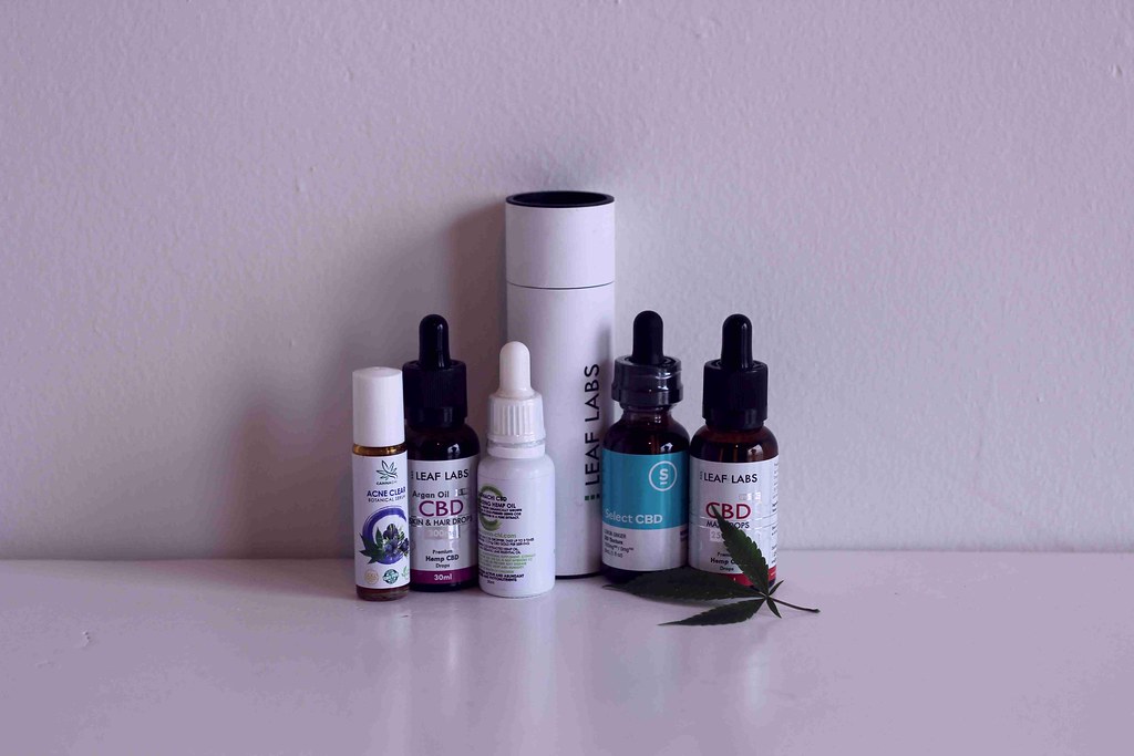 CBD oil bottles on a white shelf