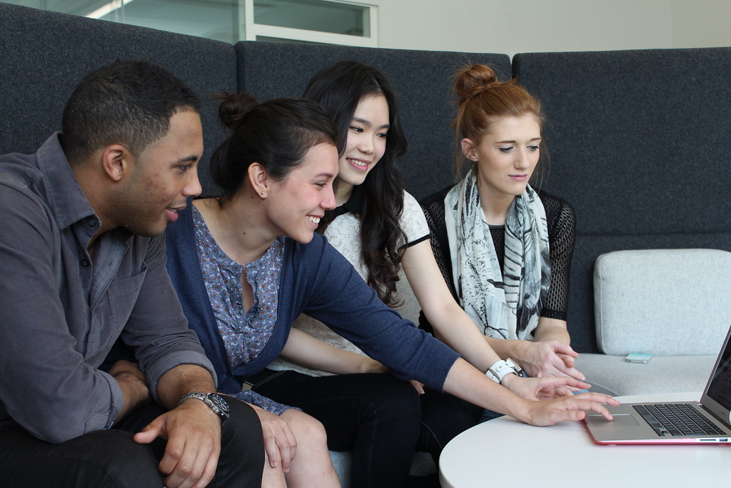 Colleagues looking at a laptop together